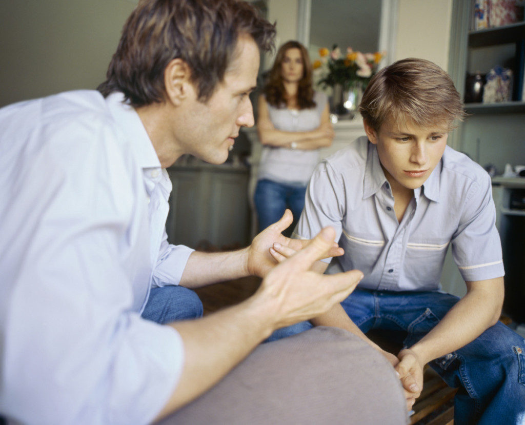 Side angle of father talking to his son